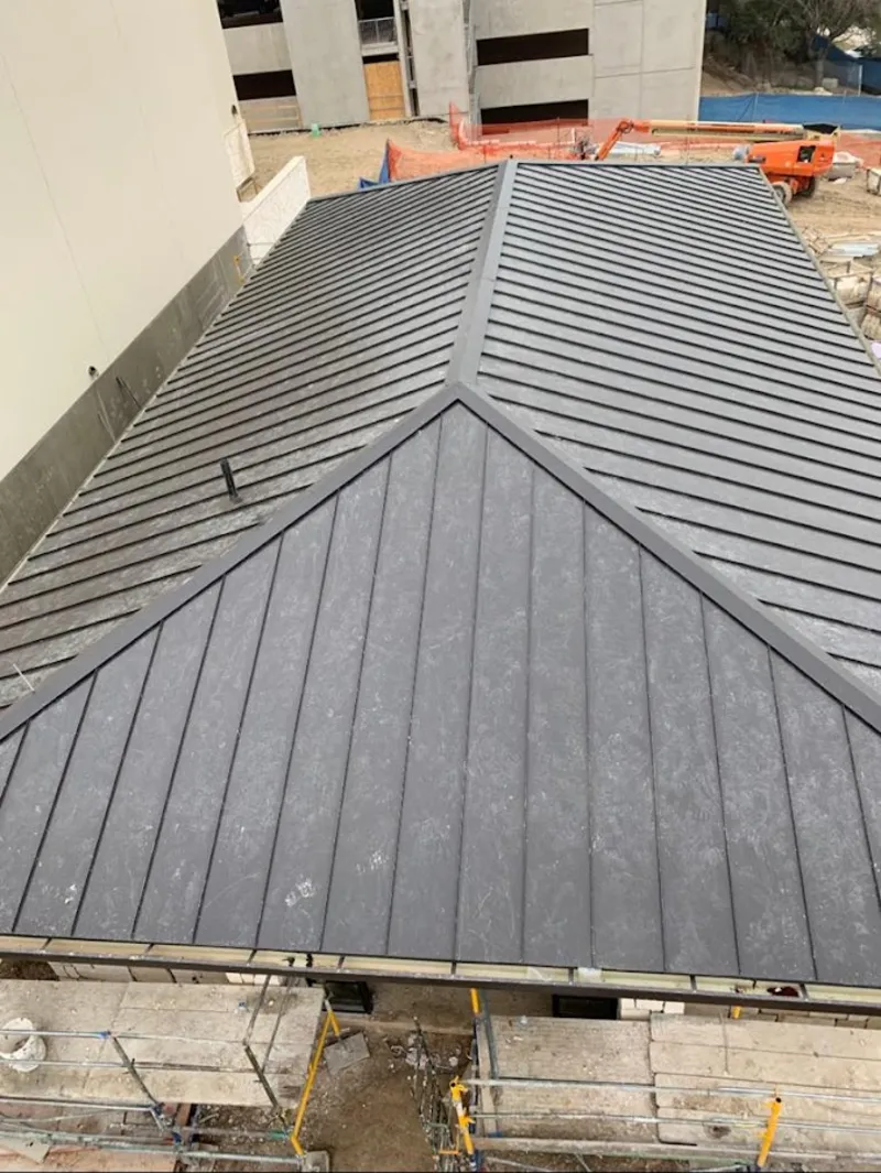 Commercial metal roof construction with crane equipment in Great Bend