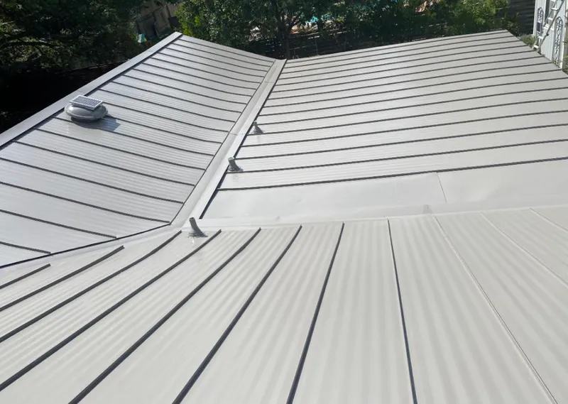 Solar attic fan installed on a metal roof for Roof Ventilation in Great Bend